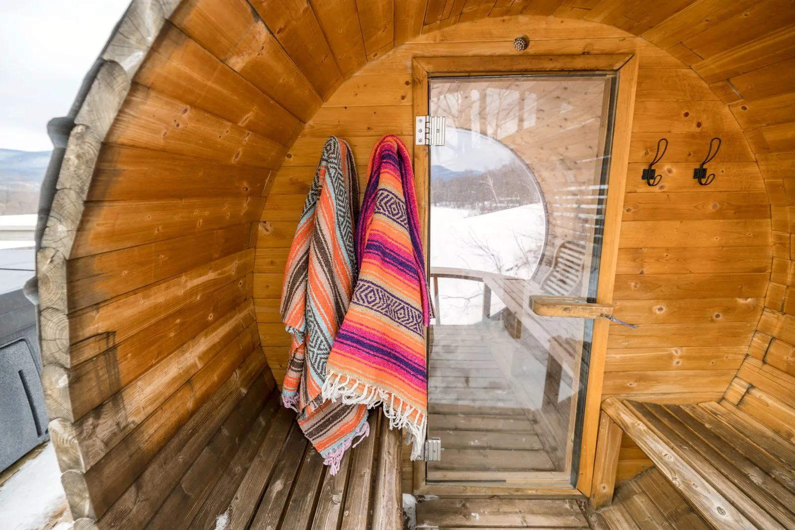 Clean pale-wood sauna benches with a towel laid on top