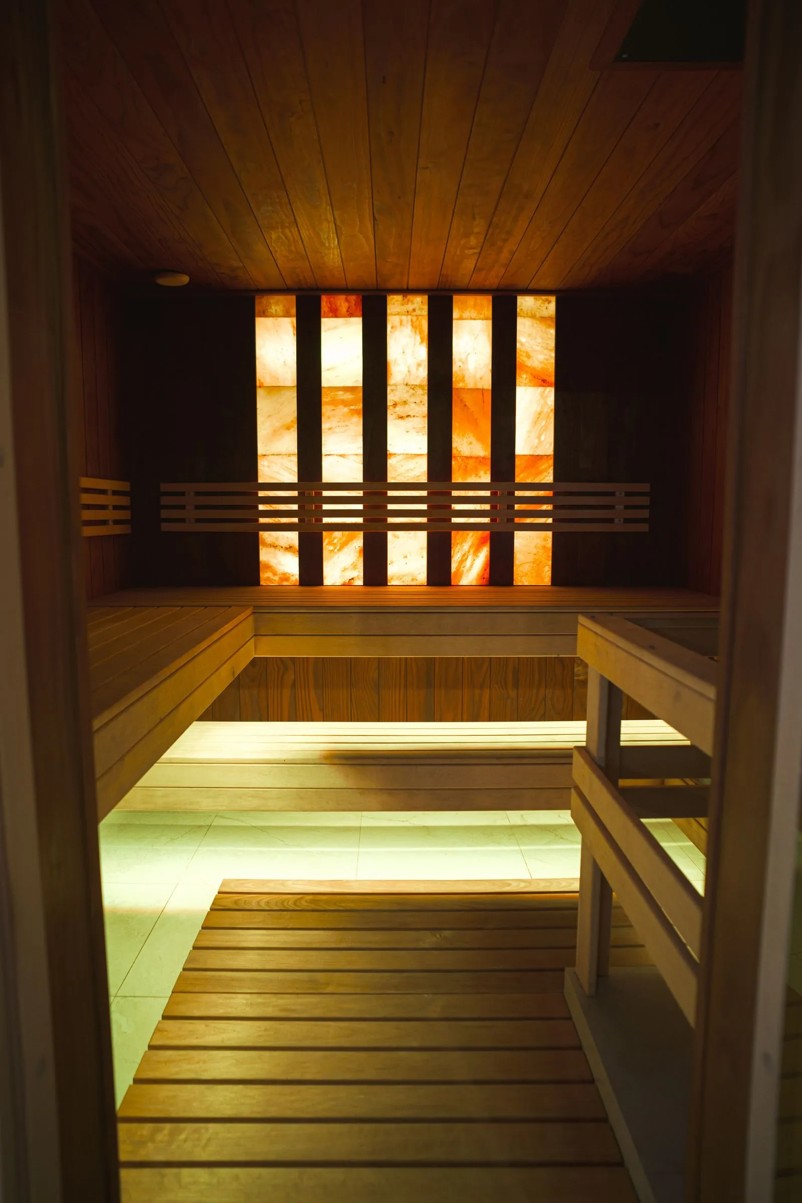 A tidy shared sauna with towels laid on the benches