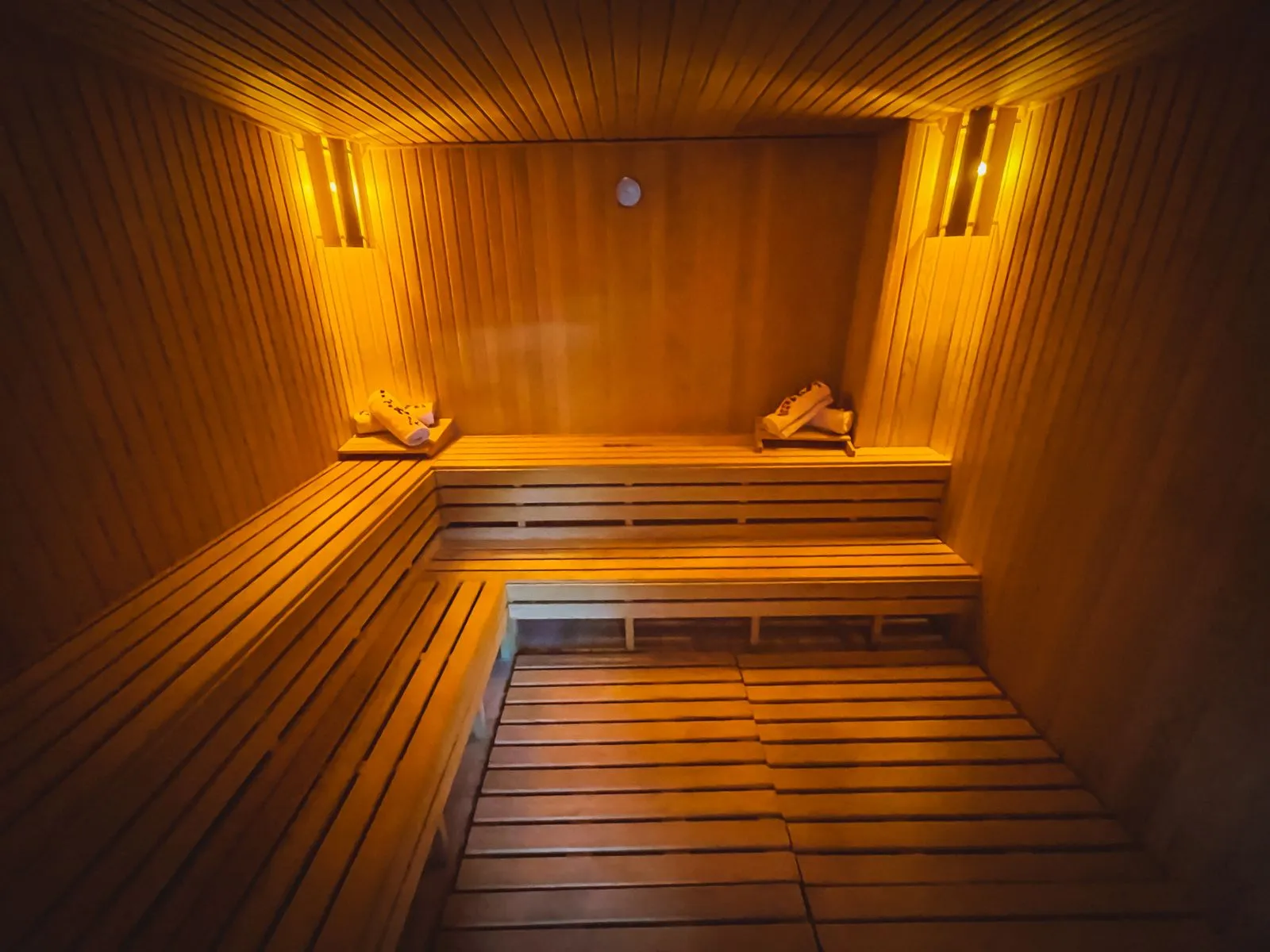 A quiet sauna, empty, suggesting caution and rest