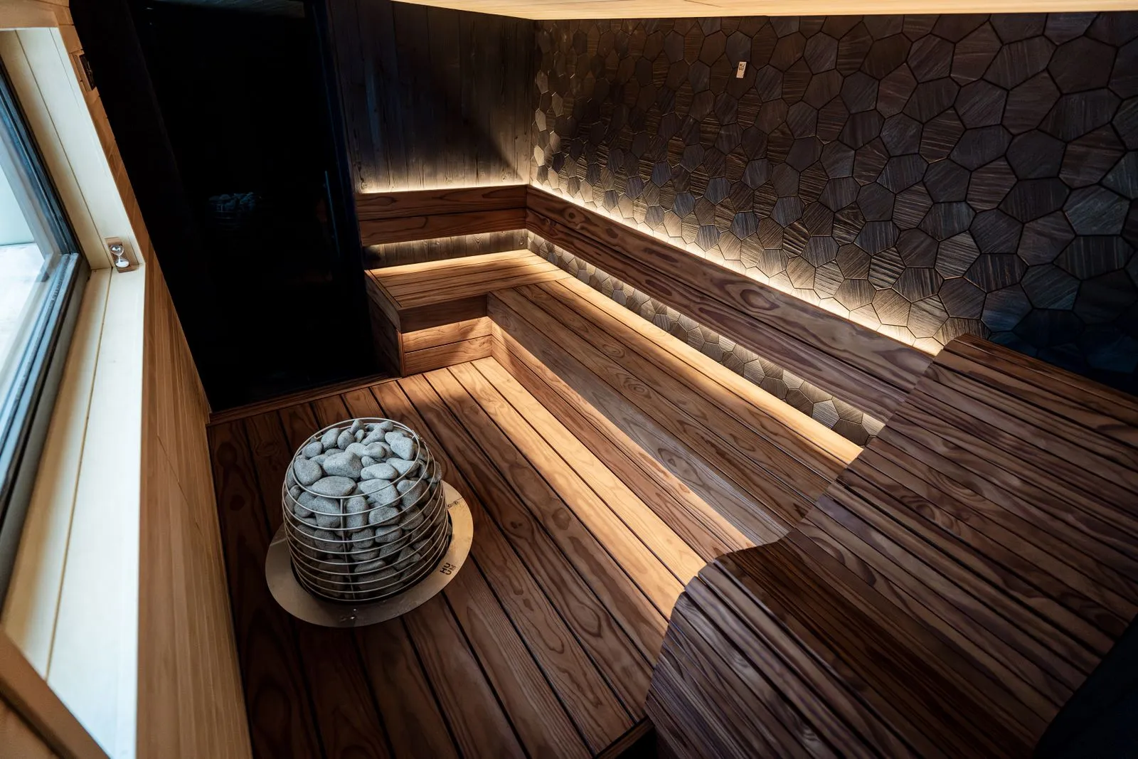 A wall-mounted sauna control with temperature sensor nearby