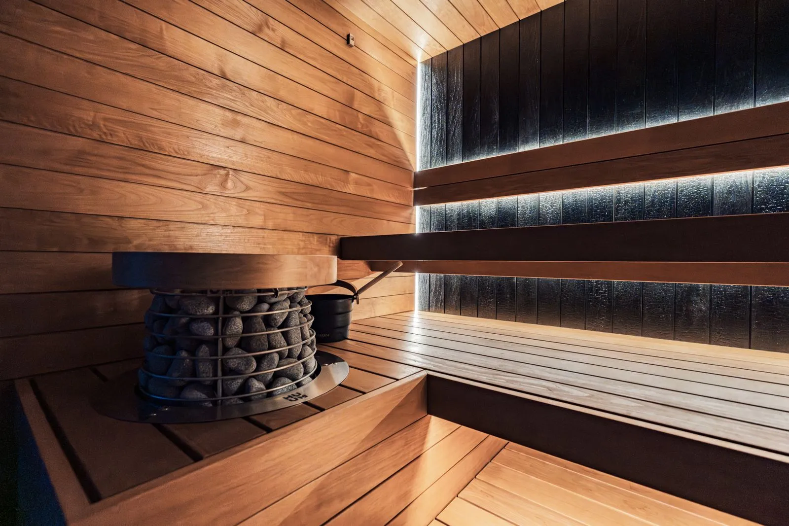Simple cleaning supplies beside a clean sauna bench