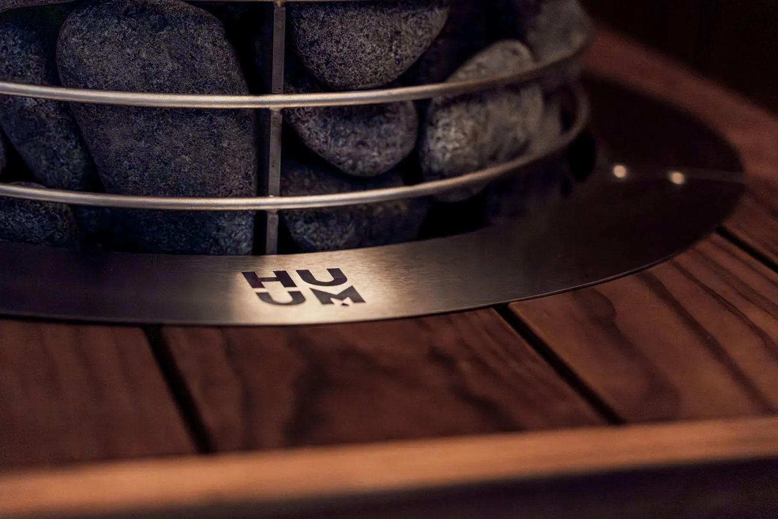 Electric sauna heater with stones, viewed in a compact sauna