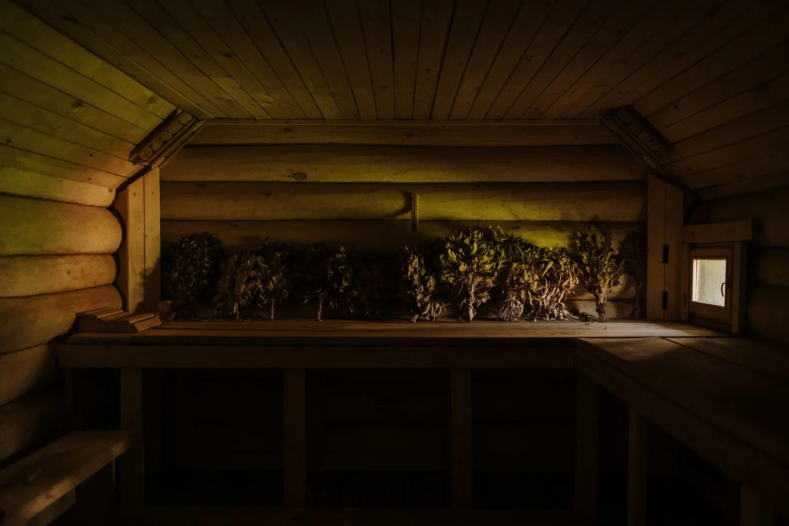 A glass of water beside a wooden sauna bench