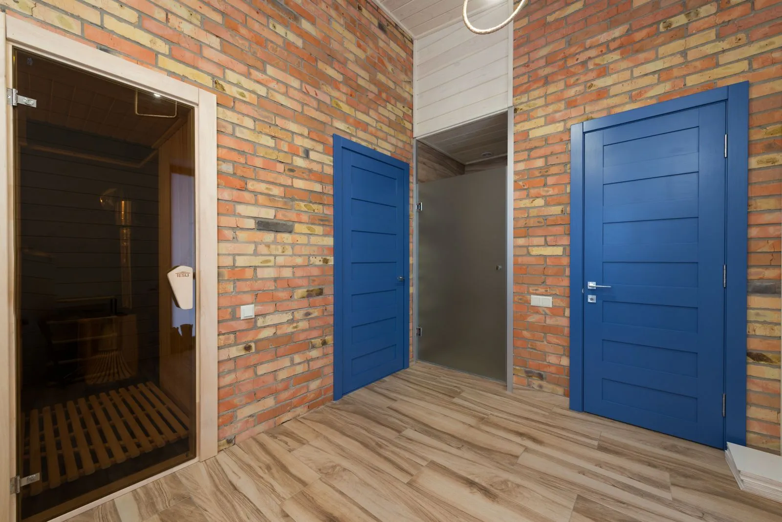 A wood-lined sauna interior with visible ventilation vents