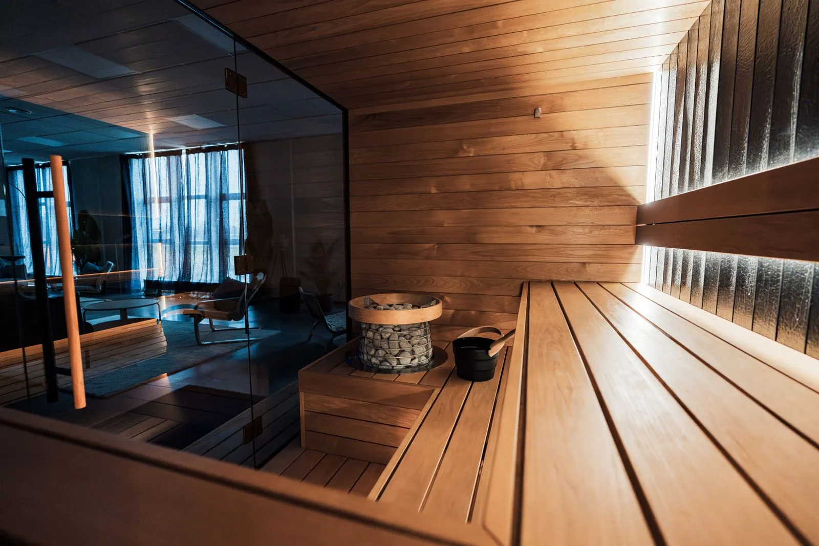 Well-kept modern sauna interior with clean benches and heater