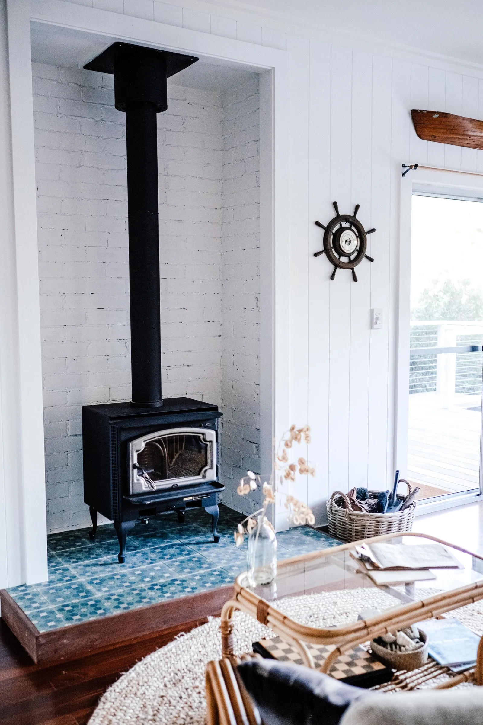 A cast wood-burning stove glowing in a timber cabin interior